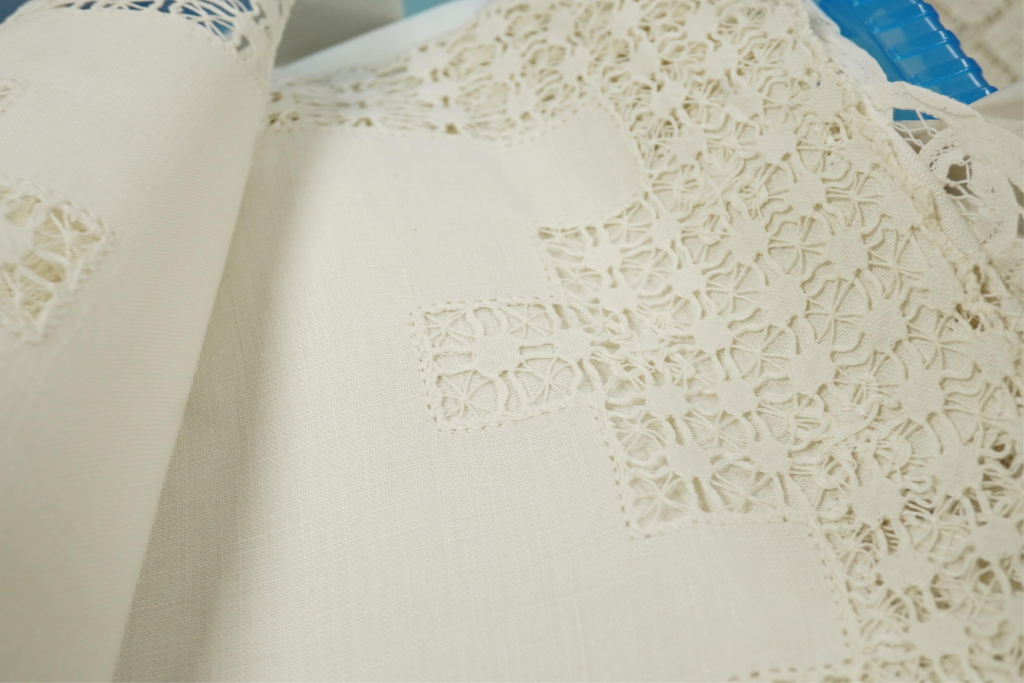 A collection of early 20th century and later crochet, cut work and drawn thread table linens and a large embroidered table cloth